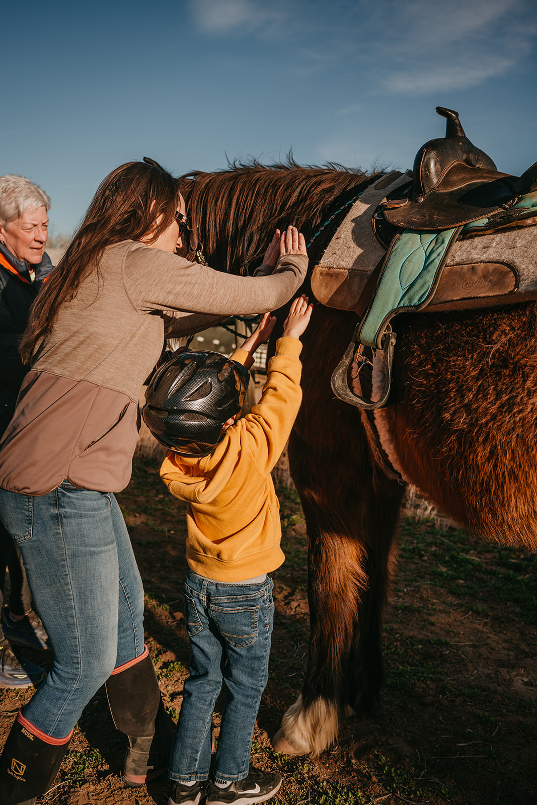 equine therapy branding photos of child thanking horse.