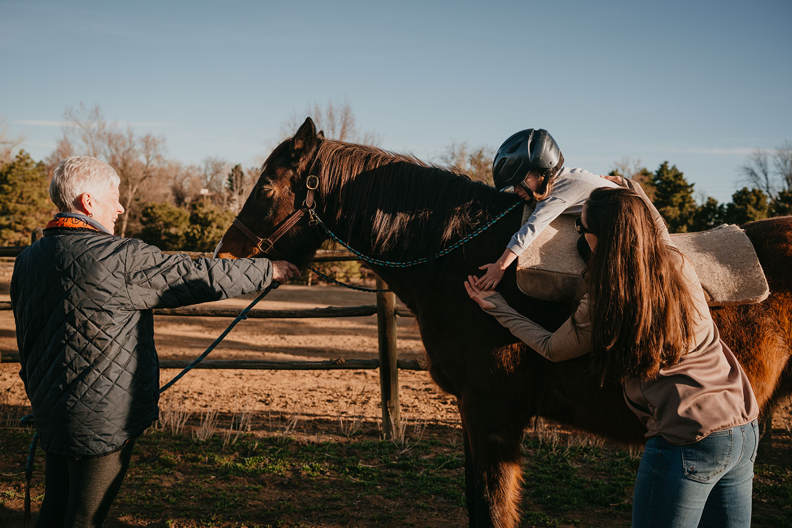equine therapy branding photos of child hugging horse.