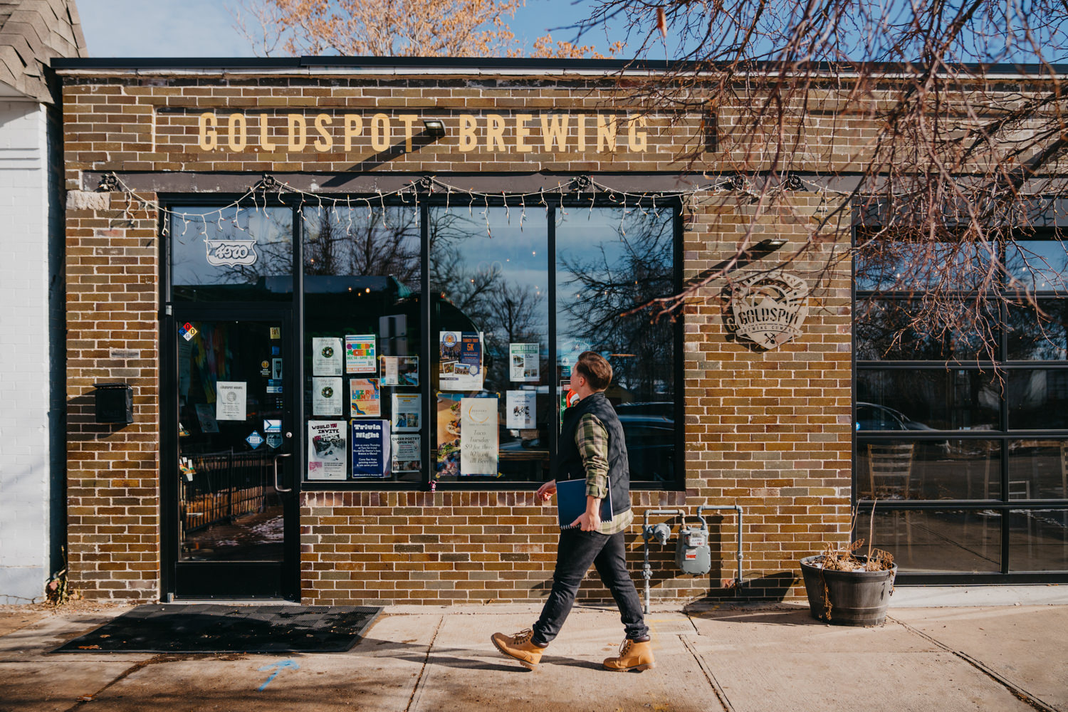 accessibility branding photo of trans man walking toward brewery