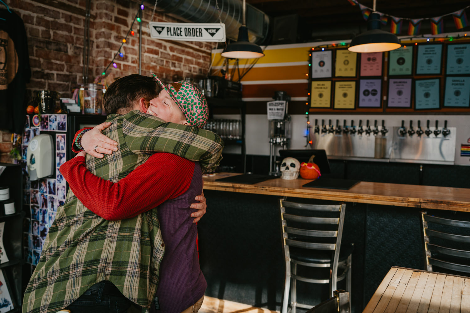 accessibility branding photo of people hugging at brewery.