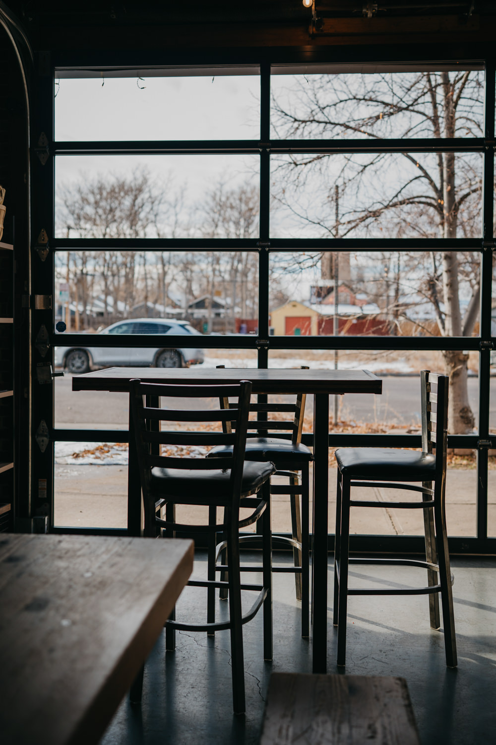 accessibility branding photo of high top tables in front of garage door.
