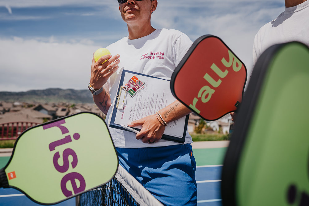 Brand photo of coach talking on pickleball court.